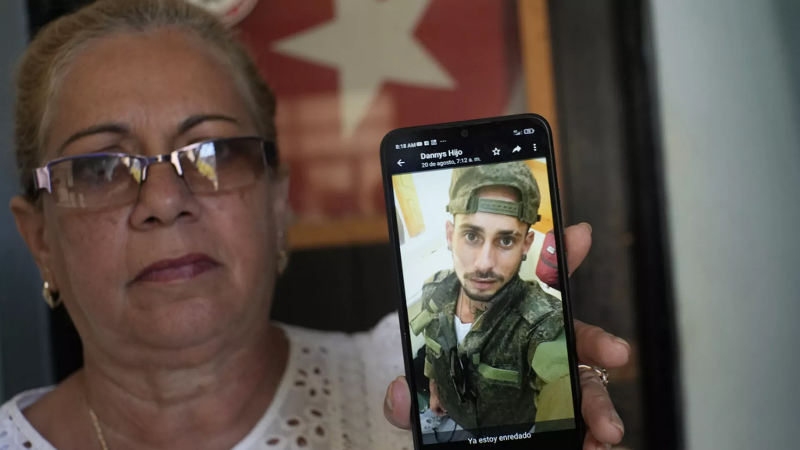 Marilin Vinent muestra foto de su hijo Dannys Castillo vestido de militar